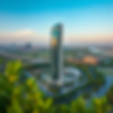 Panoramic View of Hessa Tower Amidst Urban Landscape A panoramic shot of Hessa Tower surrounded by lush greenery and urban development.